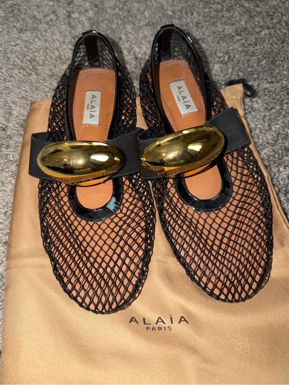 Alaia Black Mesh Ballet Flats with Gold Oval Accent